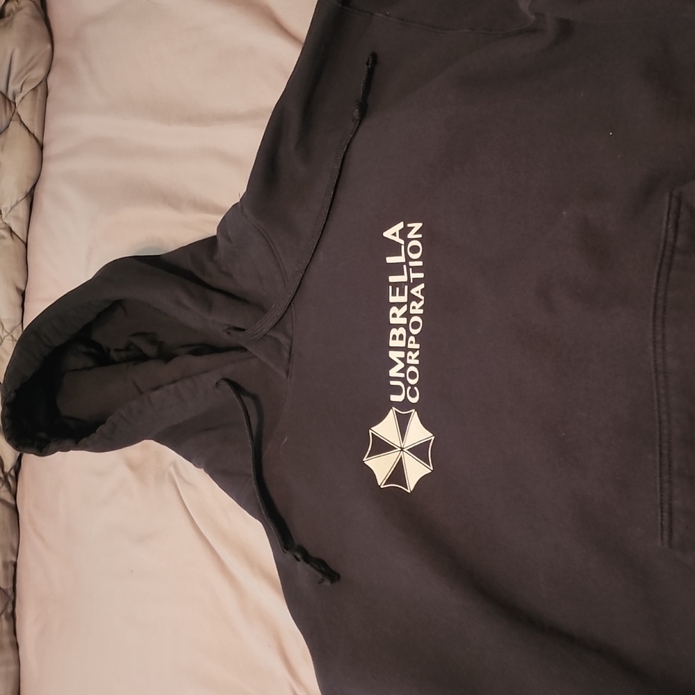 A black hooded sweatshirt with Umbrella on from, size is XL